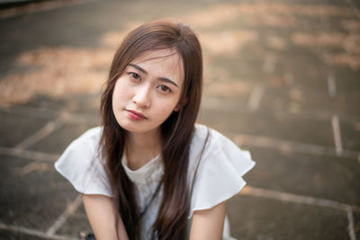 Portrait of beautiful young woman standing outdoors