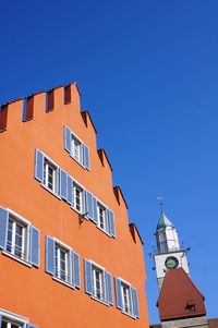 Low angle view of building against clear blue sky