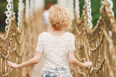 Close-up of woman standing on bench