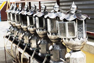 A row of oil lamp lighting in thai temple.