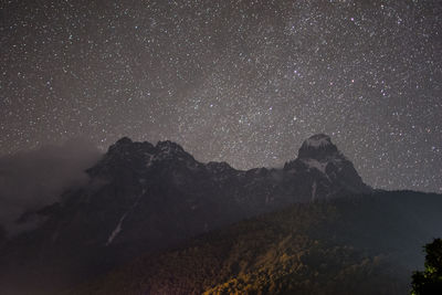 Scenic view of mountains against sky at night