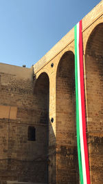 Low angle view of arch bridge against building