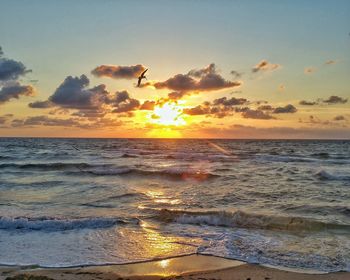 Scenic view of ocean at sunset