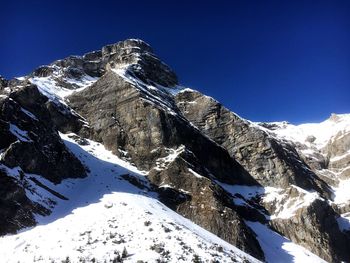 Low angle view of mountain range against sky