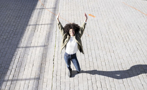 Portrait of smiling young woman standing on floor