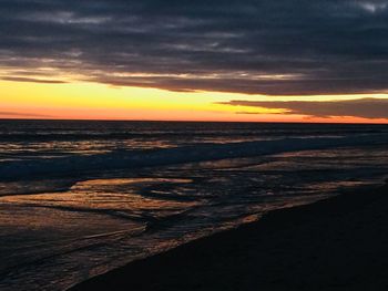 Scenic view of beach against sky during sunset