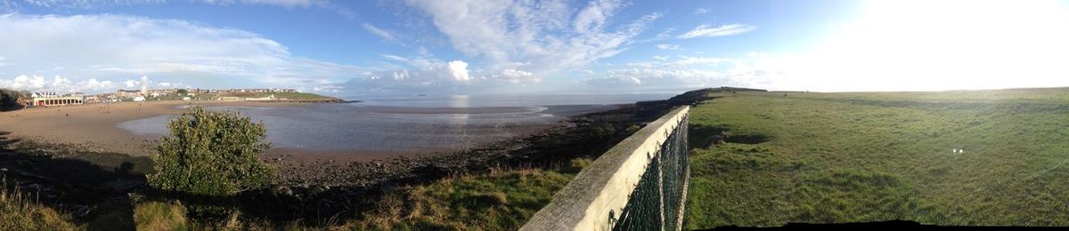 Panoramic view of road by sea against sky