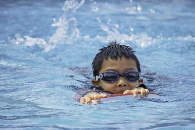 Portrait of boy swimming in pool