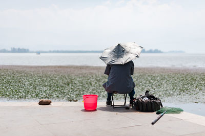 Rear view of woman drinking water