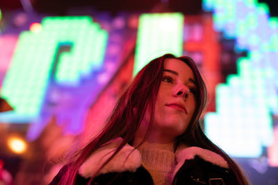 Portrait of young woman looking away outdoors