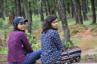 Side view of a young woman in the forest