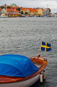 Boats moored on beach against sky