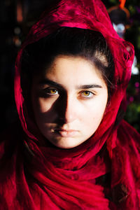 Close-up of young woman with red veil 