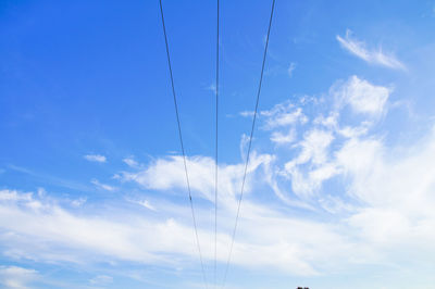 Low angle view of vapor trail against blue sky