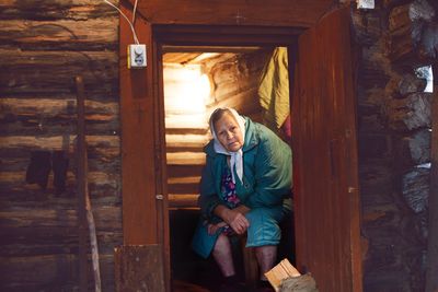 Woman standing in front of wooden door