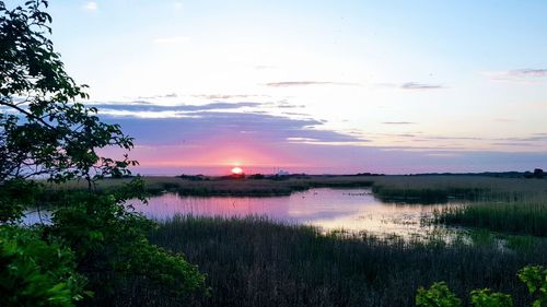 Scenic view of lake against sky during sunset