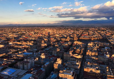 High angle shot of townscape against sky at sunset