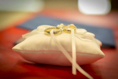 Close-up of wedding rings on table