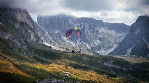 Rear view of man walking on mountain against sky