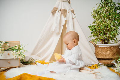 Portrait of woman sitting on sofa at home