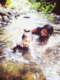 Portrait of siblings in water