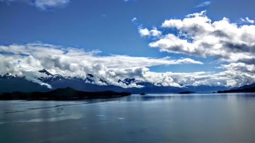 Scenic view of lake and mountains against sky