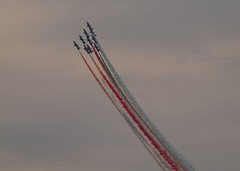 Low angle view of airplane flying against sky