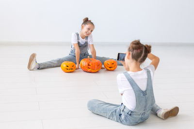 Full length of woman sitting on floor