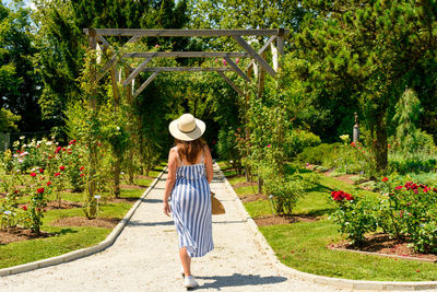 Rear view of woman walking in garden