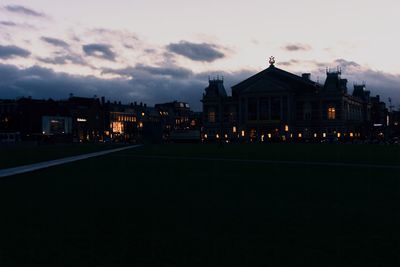 Illuminated buildings against sky at night