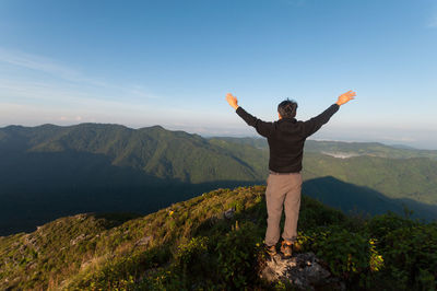 Man standing on mountain against sky