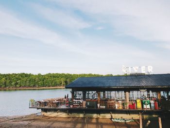 Scenic view of river by building against sky