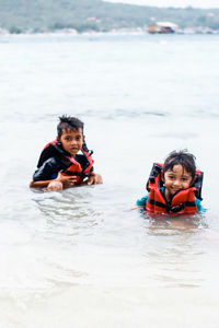 Portrait of siblings in sea