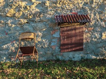 Old chairs against wall of house