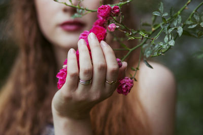 Woman's hand holding pink roses
