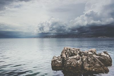 Scenic view of sea against cloudy sky