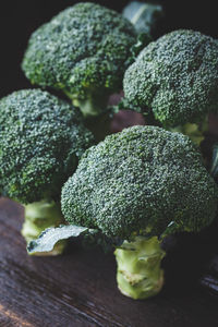 Close-up of broccolis on wooden table