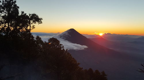 Scenic view of silhouette mountains against sky at sunset