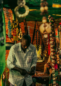 A brown skin man in a bracelets store