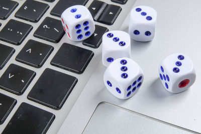 High angle view of dices on laptop