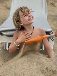 Portrait of a boy sitting on sand