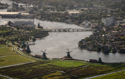 Aerial view of river amidst buildings in city