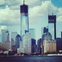 Buildings against cloudy sky