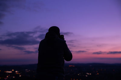 Silhouette man standing against sky during sunset