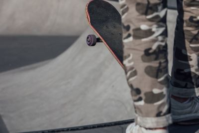 Low section of man skateboarding at playground