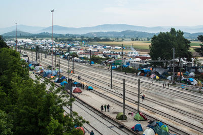 Railroad tracks amidst refugee camp tents