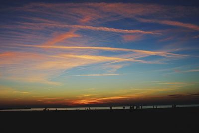 Scenic view of beach against sky during sunset