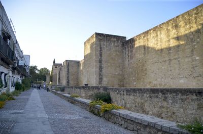 Alley amidst buildings against sky