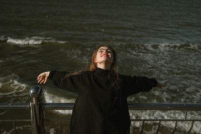 Side view of woman standing at beach