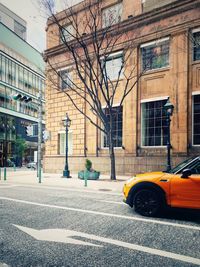 Road by buildings in city